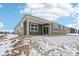 Exterior view of the home with a covered patio and a green siding at 7840 Magnolia St, New Palestine, IN 46163