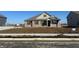 Charming single-story brick home featuring a covered front porch and a well-manicured lawn at 7840 Magnolia St, New Palestine, IN 46163