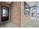 Stylish front entry featuring a modern door with glass panel and contemporary hardware at 7840 Magnolia St, New Palestine, IN 46163