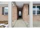 Elegant entryway showcasing a classic front door with sidelights and decorative hardware at 7840 Magnolia St, New Palestine, IN 46163