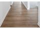 Hallway view of luxury vinyl plank flooring with white base trim along the walls at 7840 Magnolia St, New Palestine, IN 46163