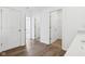 Hallway with wood floor leads to rooms, showing spacious interior layout at 7840 Magnolia St, New Palestine, IN 46163