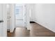 Welcoming hallway with wood-look floors and white trim, seamlessly connecting different areas of the home at 7840 Magnolia St, New Palestine, IN 46163