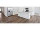 Kitchen boasts stainless appliances, island with sink, and white countertops at 7840 Magnolia St, New Palestine, IN 46163