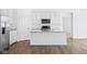 Kitchen boasts stainless appliances, island with sink, and white countertops at 7840 Magnolia St, New Palestine, IN 46163