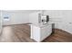 Bright kitchen features white cabinetry, stainless appliances, and a large island with a double sink at 7840 Magnolia St, New Palestine, IN 46163