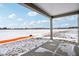 Covered patio with concrete surface, overlooking the snowy backyard at 7840 Magnolia St, New Palestine, IN 46163