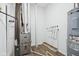 Utility room featuring a water heater, furnace, and other essential home systems on vinyl flooring at 7840 Magnolia St, New Palestine, IN 46163