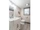 Bathroom with a farmhouse sink, modern faucet, and white toilet at 11197 N Gasburg Rd, Mooresville, IN 46158