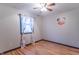 Charming bedroom with hardwood floors, ceiling fan, and Mickey Mouse decor accents at 11197 N Gasburg Rd, Mooresville, IN 46158