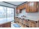 Bright eat-in kitchen with barstool seating, and a sliding glass door leading outside at 11197 N Gasburg Rd, Mooresville, IN 46158