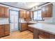 Cozy kitchen with white countertops, wooden cabinets, and an exterior access door at 11197 N Gasburg Rd, Mooresville, IN 46158