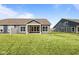 Green backyard includes a cozy, covered patio for enjoying tranquil outdoor living with adjacent houses nearby at 16892 Cattle Hollow Ln, Noblesville, IN 46060