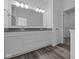 Bathroom with double vanity, large mirror, walk in closet, and modern lighting at 16892 Cattle Hollow Ln, Noblesville, IN 46060