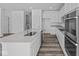 Kitchen island featuring a stainless sink, and dishwasher with stainless oven and range at 16892 Cattle Hollow Ln, Noblesville, IN 46060
