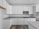 Bright kitchen featuring white cabinetry, modern appliances, and gray countertops at 16892 Cattle Hollow Ln, Noblesville, IN 46060