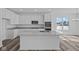 Modern kitchen features a central island, stainless appliances, and views to the backyard at 16892 Cattle Hollow Ln, Noblesville, IN 46060