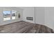 Modern living room features a fireplace, luxury vinyl plank flooring, and large windows at 16892 Cattle Hollow Ln, Noblesville, IN 46060