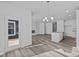 Open concept living area boasts modern lighting, a fireplace, and access to the backyard at 16892 Cattle Hollow Ln, Noblesville, IN 46060