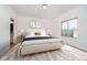 Well-lit bedroom with light colored walls, neutral decor, and a large window at 202 Asbury Dr, Anderson, IN 46013