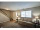 Simple living room with beige couch and entryway at 23 Trails End St, Greenwood, IN 46142