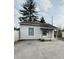 A charming home with a small front porch featuring wooden support beams, a white front door, and a satellite dish at 2342 Hoyt Ave, Indianapolis, IN 46203