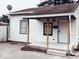 A charming home with a small front porch featuring wooden support beams and a white front door at 2342 Hoyt Ave, Indianapolis, IN 46203