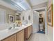 Bathroom with double vanity sinks, large mirror, and a view into the toilet room at 316 Northpointe Ct, Danville, IN 46122