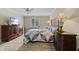 Bedroom with a queen bed, wood floors, and dark wood dressers at 316 Northpointe Ct, Danville, IN 46122