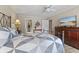 Bedroom with a queen bed, ceiling fan, and a view into the bathroom at 316 Northpointe Ct, Danville, IN 46122