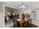 Open concept dining room features a modern chandelier and seamless flow to kitchen at 316 Northpointe Ct, Danville, IN 46122