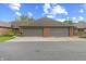 Brick home featuring a two-car garage with gray doors and a concrete driveway at 316 Northpointe Ct, Danville, IN 46122