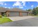 Brick home featuring a two-car garage with gray doors, concrete driveway, and landscaping at 316 Northpointe Ct, Danville, IN 46122
