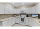 Bright kitchen featuring white appliances, ample counter space and stylish cabinets at 316 Northpointe Ct, Danville, IN 46122