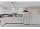 Functional kitchen with a neutral-tone backsplash, white appliances, and ample cabinet space at 316 Northpointe Ct, Danville, IN 46122