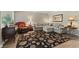 Comfortable living room with a large sectional, dark floral rug, and hard wood floors at 316 Northpointe Ct, Danville, IN 46122