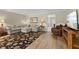 Comfortable living room with a large sectional, dark floral rug, and hard wood floors at 316 Northpointe Ct, Danville, IN 46122