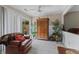 Relaxing sun room with lots of plants, a love seat, and access to the backyard at 316 Northpointe Ct, Danville, IN 46122