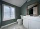 Bathroom with single vanity, toilet, and window at 4140 Melbourne Rd, Indianapolis, IN 46228