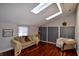 Living room with hardwood floors, sofa, and skylights at 4140 Melbourne Rd, Indianapolis, IN 46228