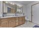The bathroom features double sinks with wood cabinets, a tile floor, and a neutral color scheme at 4208 E Epler Ave, Indianapolis, IN 46237