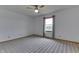 Neutral bedroom featuring a ceiling fan, natural light from the window, and patterned carpeting at 4208 E Epler Ave, Indianapolis, IN 46237