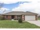 Charming single-story red brick home with an attached two-car garage and well-maintained lawn at 4208 E Epler Ave, Indianapolis, IN 46237