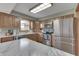 This kitchen features wood cabinets, stainless steel appliances, and a marble countertop island at 4208 E Epler Ave, Indianapolis, IN 46237