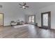 Bright living room featuring hardwood floors, a ceiling fan, and a large window at 4208 E Epler Ave, Indianapolis, IN 46237