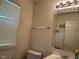 Bathroom featuring a vanity, toilet, mirror with patterned border, and a window with blinds at 672 Rocky Meadow Dr, Greenwood, IN 46143