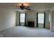 Bright living room featuring a fireplace, neutral carpet, and natural light from the double window at 672 Rocky Meadow Dr, Greenwood, IN 46143