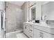 Modern bathroom with double vanity, large shower, and neutral tile at 9895 Baneberry Ln, Carmel, IN 46290