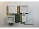 Kitchen design samples with white and green cabinets and marble countertops at 9895 Baneberry Ln, Carmel, IN 46290