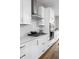 Modern white kitchen with stainless steel appliances and quartz countertops at 9895 Baneberry Ln, Carmel, IN 46290